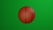 Classic basketball ball rotates on green background.