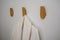 Classic bathrobe hanging on wooden abstract wall hook mounted ag