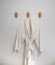 Classic bathrobe hanging on wooden abstract wall hook mounted ag