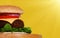 Classic beef burger on sunny yellow background