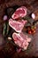 Classic beef steaks on a wooden Board. Raw meat in chunks. Rib eye, porterhouse, and t-bone raw. Copy of the space. Top view