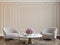 Classic beige interior with armchairs, coffee table, flowers and wall moldings.