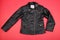 Classic black leather bikers` kids female jacket on red bakground