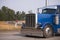 Classic blue big rig semi truck with chrome accessories running