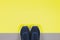 Classic blue sneakers on the yellow and grey background. Concept for healthy lifestyle and everyday training