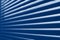 Classic blue tone close-up modern plastic shutter blinds in office room. trendy 2020 color pantone jalousie