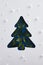 Classic blue xmas tree silhouette made with green leaf and snowfall pattern