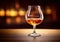 Classic brandy cognac glass on golden blurry background.Macro.AI Generative