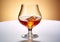Classic brandy cognac whiskey glass on golden background.Macro.AI Generative