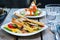 Classic breakfast, hot sandwiches with cheese, vegetables and chicken on a wooden table.