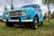 Classic bright blue Renault 4 L car on a field