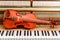 classic brown violin on the close up image of grand piano keys and interior background