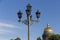 Classic candelabra street light with five lamps. Saint Isaac`s Cathedral`s golden cupola in background