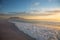 Classic Cape TOwn and Table Mountain view. Late afternoon with sun low and some cloud cover with ocean and waves in foreground