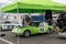 Classic car being prepared for a motorsport race in the paddock area