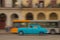 Classic car panning shot with bus in background, Havana