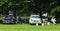 Classic cars and owners having a picnic on the village green. Truimph Herald and MG motor Cars.