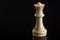 Classic Chess White Queen on black surface, isolated