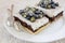 Classic Chester Cake slices with blueberries and Cilantro flower
