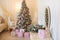 Classic Christmas decorated interior room with New year tree. Modern luxury design apartment bedroom with bed. Christmas