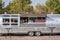 Classic chrome food wagon in park. Food truck