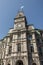 Classic clocktower building Quebec City Canada with flag of quebec on a sunny day blue sky