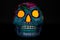 A classic colorful Mexican skull with bright orange eyes on a black background