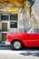 Classic convertible car next to a shabby building in Old Havana