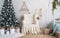 Classic covered armchair beside decorated Christmas tree with a ladder and dream catcher hanged on the wall