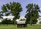 Classic covered wagon with trees in a park