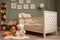 Classic crib complements a tranquil nursery with toys, a plush carpet, and a woven basket