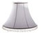 Classic cut corner bell shaped white tapered lampshade with a beaded fringe on a white background isolated close up  shot