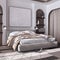 Classic dark wooden bedroom with master bed, parquet floor, niches and carpet in white and beige tones. Arched door with curtains