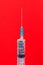 A classic disposable syringe filled with symbolic hearts. Love concept. Background with copy space. Red backdrop