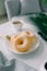 Classic donut and coffee on white table.