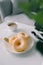 Classic donut and coffee on white table.