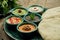 Classic eastern snacks with pita - meze. Set in small bowl - Hummus, hot pepper paste often with walnuts, yogurt, eggplant paste