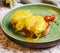 Classic egg benedict on green plate
