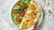 Classic egg omelette served with cherry tomato and arugula salad on side