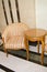 Classic elegant armchair and a small wooden table with curved legs, made in vintage retro style, marble floor and walls in the