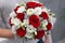 Classic emotional wedding bouquet of white and red roses