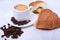 Classic espresso in white cup, croissant and coffee beans on white background. Top view.