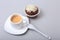 Classic espresso in white cup with homemade cake and chocolate on white background.