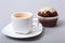 Classic espresso in white cup with homemade cake and chocolate on white background.