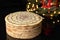 Classic esterhazy cake on black background with christmas lights, horizontal view from above