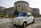 Classic Fiat Cinquecento in front of Medieval Aragonese Castle in Otranto, Apulia, Italy