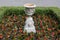 Classic Flower Pedestal in Garden Flowerbed