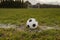 Classic foot ball on a green grass pitch. Outdoor training concept. Nobody. Sport theme background