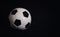 Classic football ball isolated on a black background with copy space for publicity and advertising. Real photo, traditional soccer