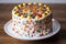 classic fruit cake, decorated with icing and colorful sprinkles